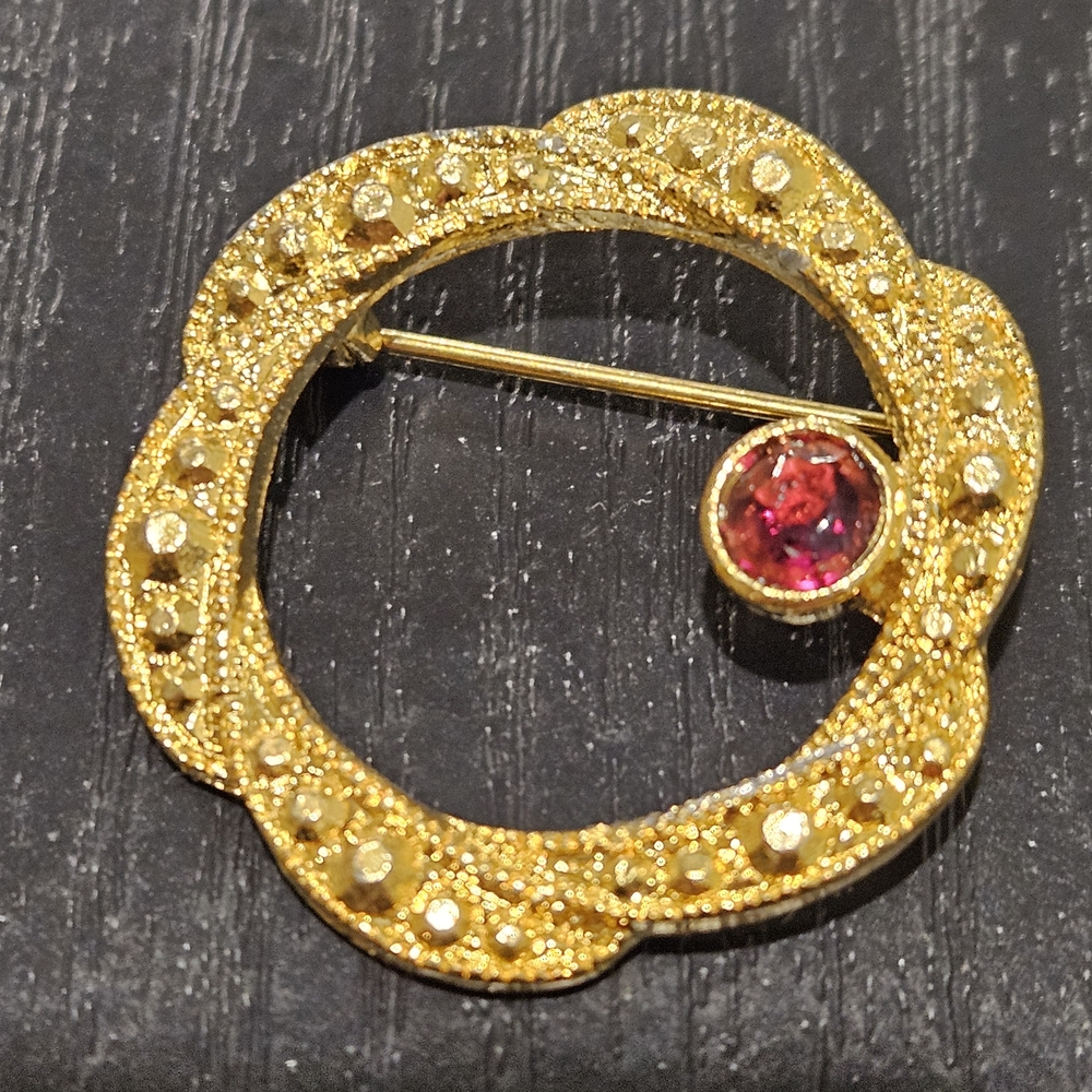 Gold Tone Circle Brooch with Red Rhinestone Accent